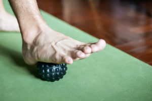 foot step on massage ball to relieve Plantar fasciitis or heel pain.