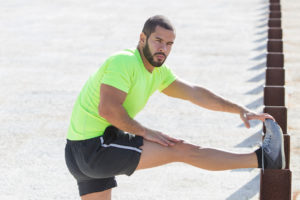 man stretching his ankle