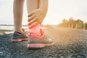 Ankle twist sprain accident in sport exercise running jogging.sprain or cramp Overtrained injured person when training exercising or running outdoors.