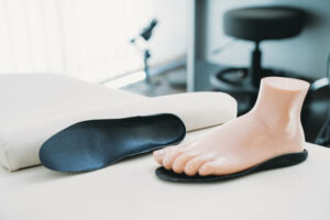 Footprints with mannequin feet - Podiatry concept. Podiatrist medical clinic.