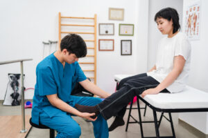 Teenager girl going to the sport medicine doctor with leg pain