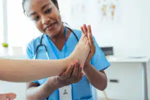 Ankle Specialist examining childs feet in hospital